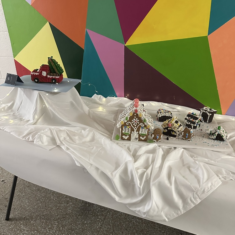 two gingerbread houses on white snowy background