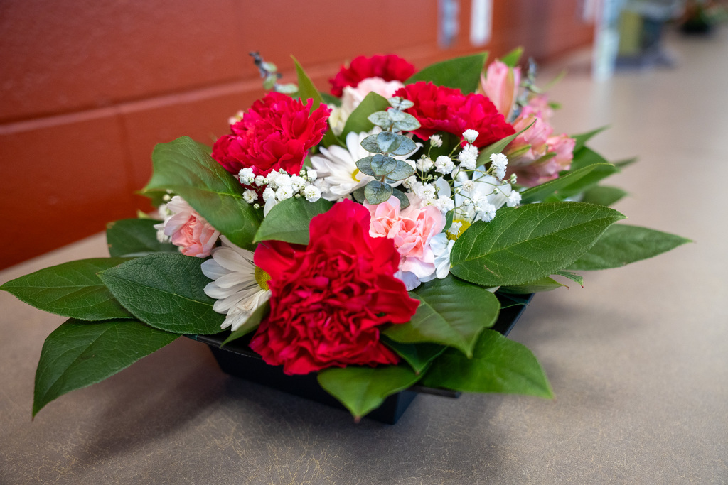 A beautiful floral arrangement with white, pink, and red flowers