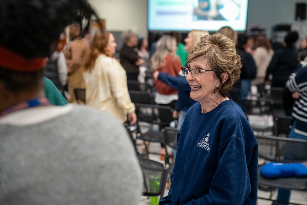 An office staff at Hawfields smiles during a professional development session