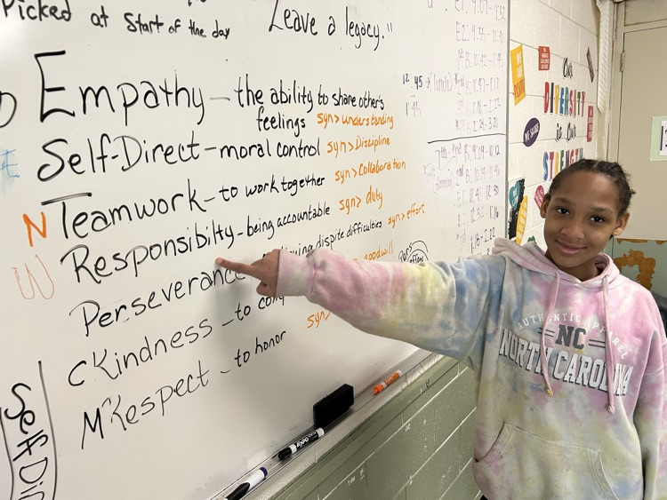 a student pointing to the word Responsibility on a whiteboard