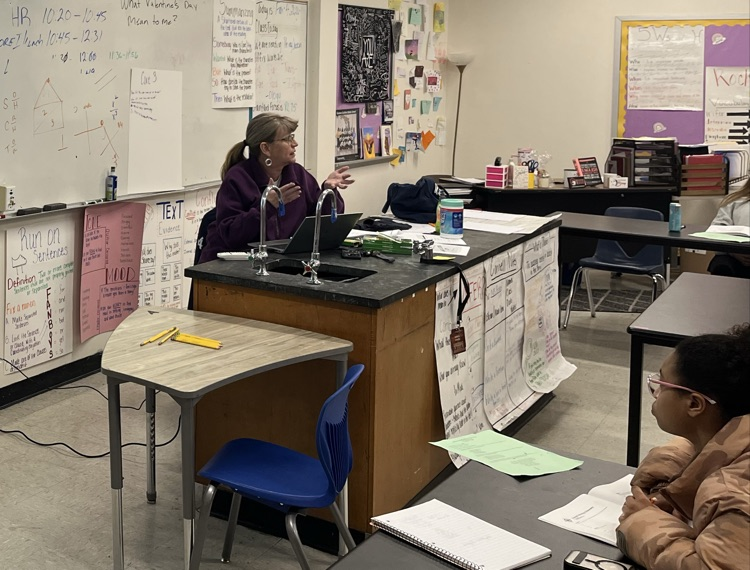 A teacher leads ACT prep lessons in front of a smart board
