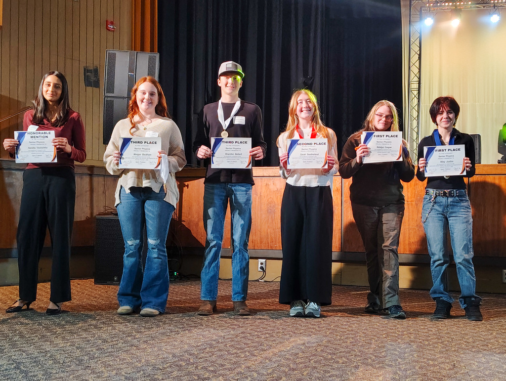 Six participants in the Region 5 science fair on stage being recognized