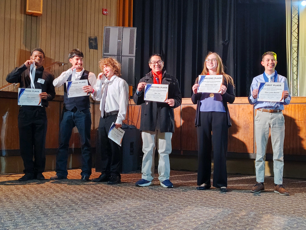 Six participants in the Region 5 science fair on stage being recognized