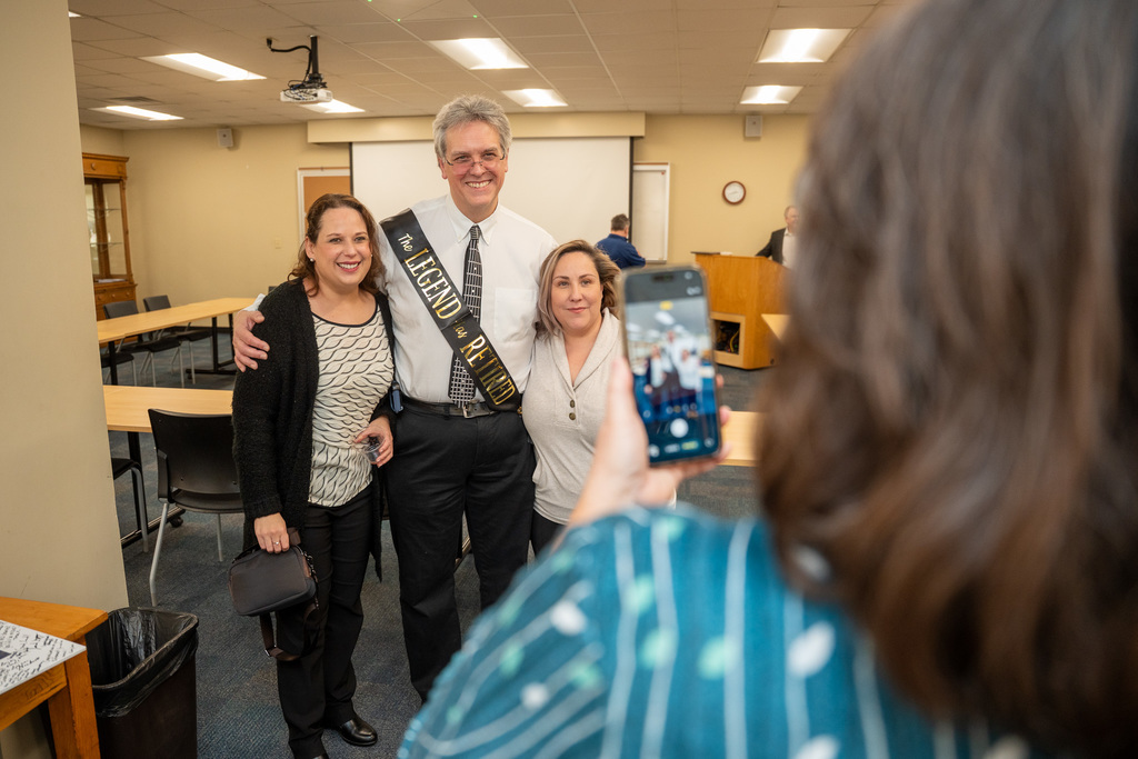Dave posing for a photo with staff
