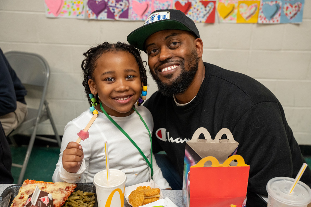 Board member Seneca Rogers posing with his nephew in the cafeteria at lunch