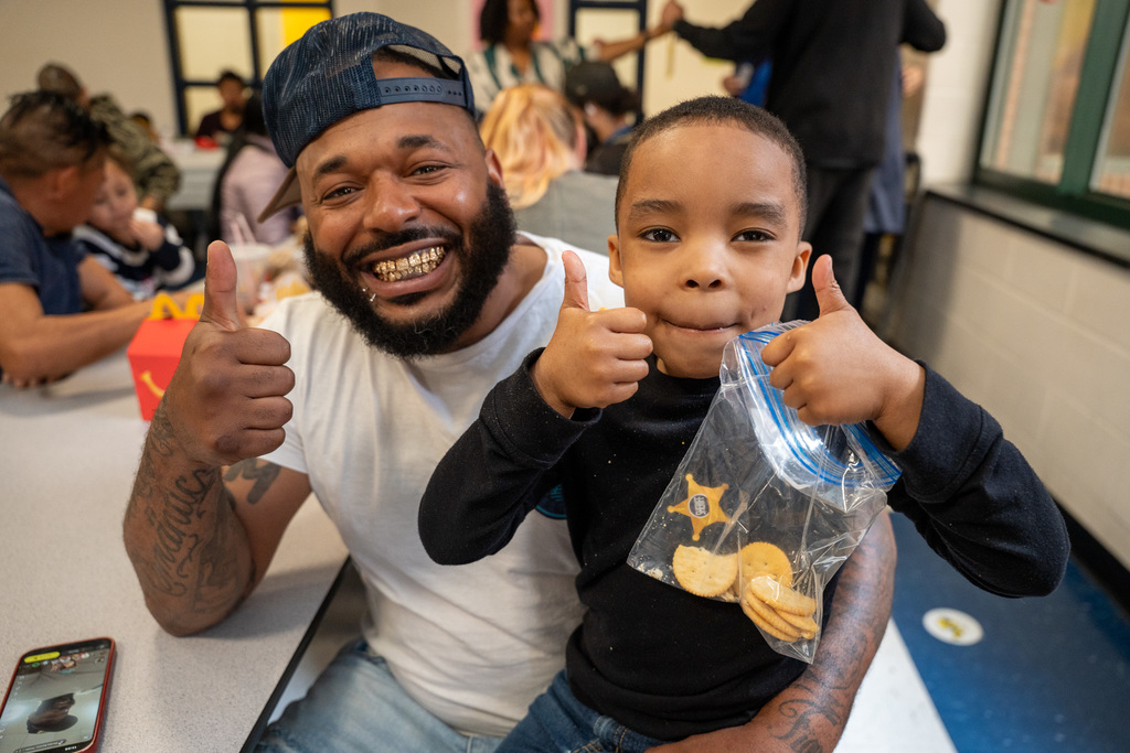 A parent and his student gives a thumbs up
