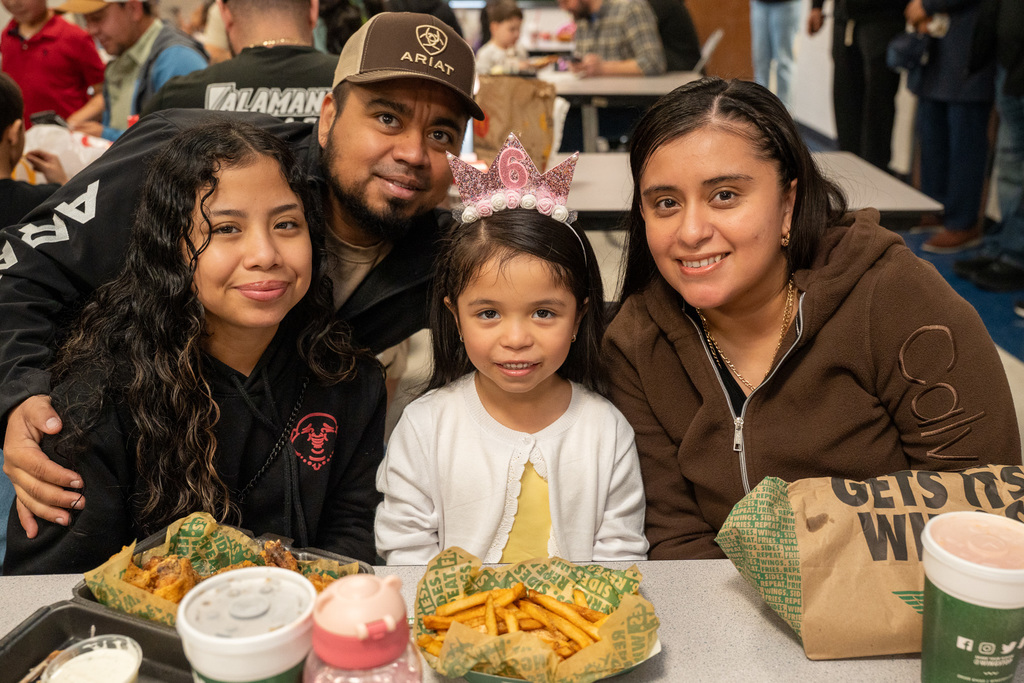 A family eating with a Hillcrest student in the cafeteria