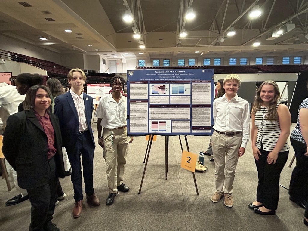 A group of five Williams High students standing beside their research project
