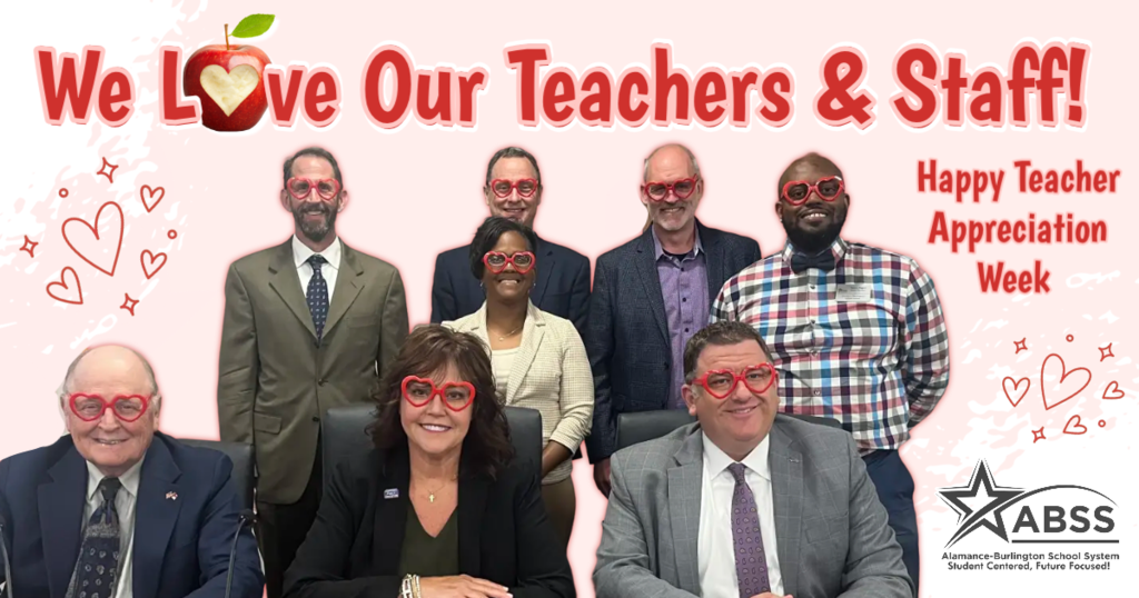 Group photo of the Board of Education with heart shaped glasses with text We Love Our Teachers & Staff!