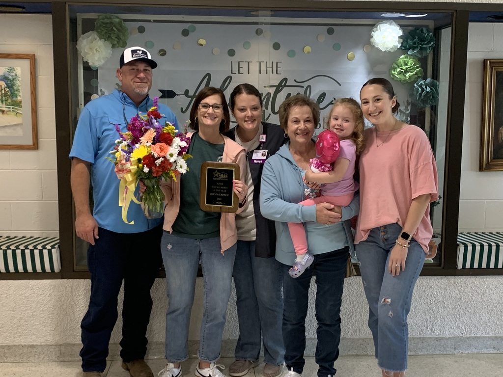 Nurse Babb stands with family during her recognition as Nurse of the Year