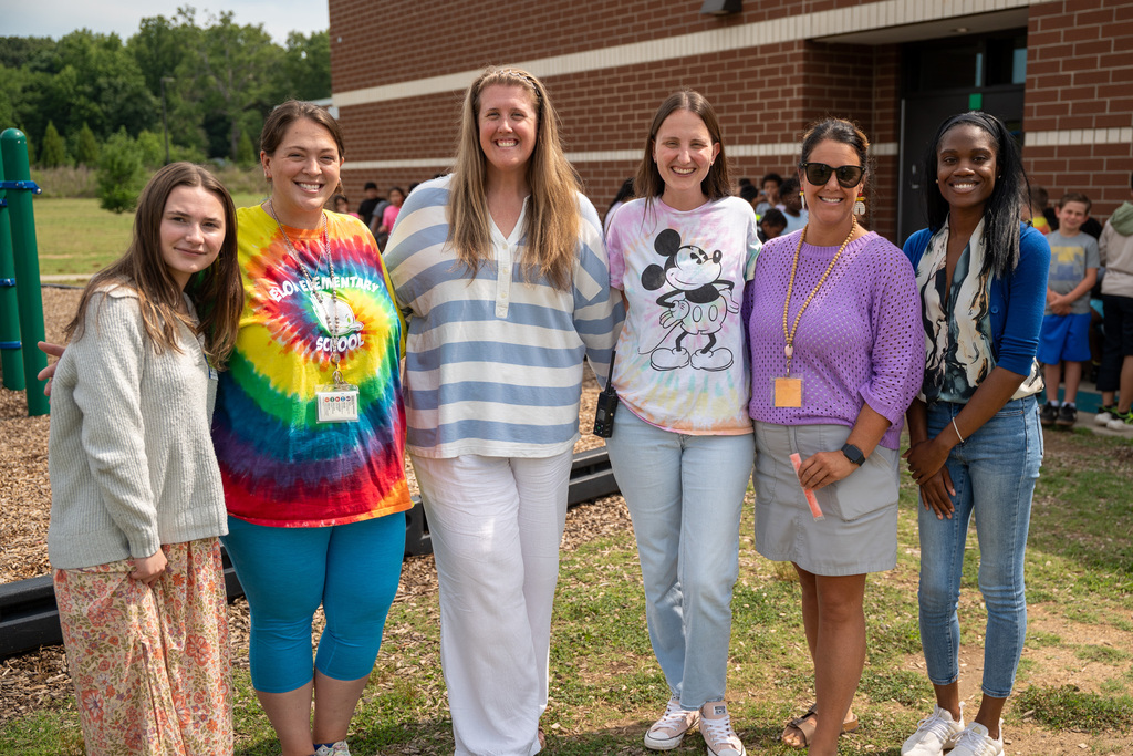 Six elementary reading camp leaders pose for a photo outside