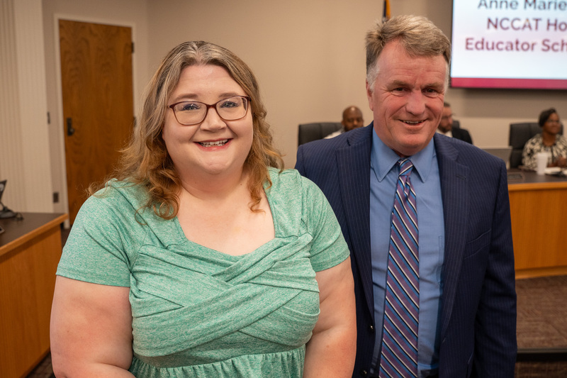 Ashley in a green shirt standing next to NCCAT representative