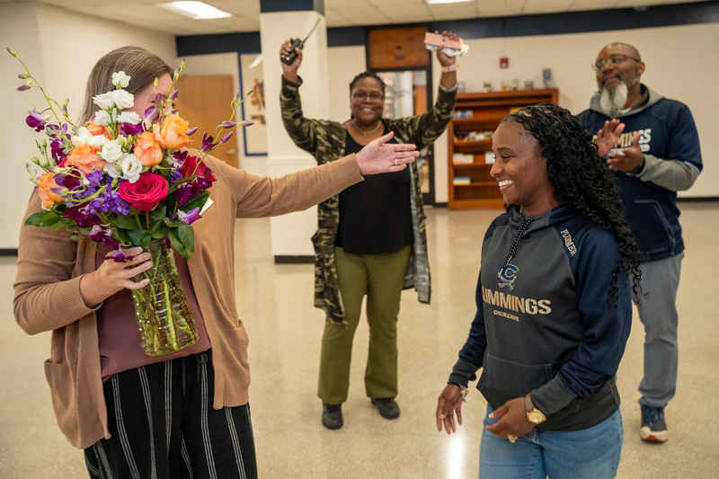 Jasmine is surprised in the hallway by district and school staff