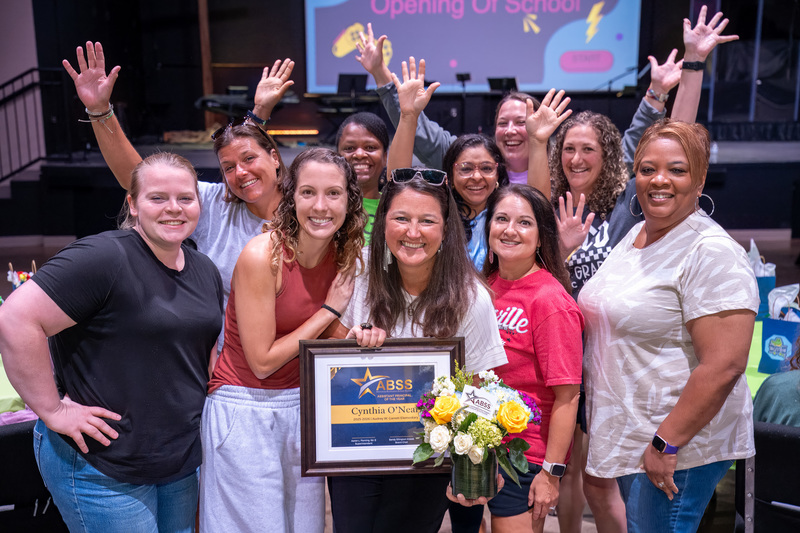 Garrett Elementary staff gather around Cynthia O'Neal and celebrate her recognition as Assistant Principal of the Year