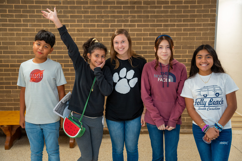 Annie Goldberg standing with four teenagers in a hallway at Broadview