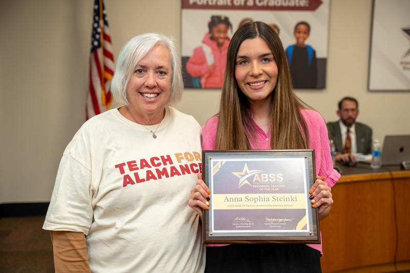 Dean Bullock from Elon University and Beginning Teacher of the Year Anna Steinki holding a certificate
