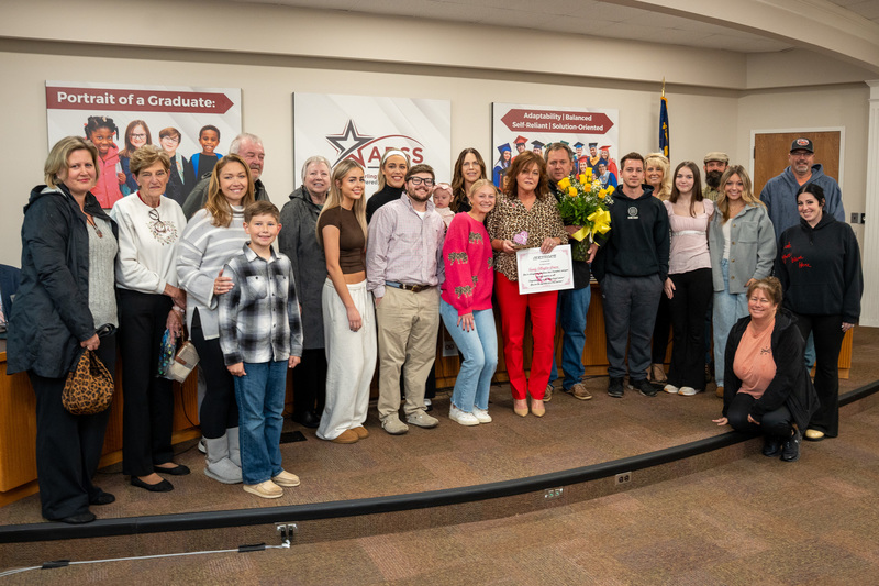Sandy Ellington-Graves with her family in front of the Board auditorium