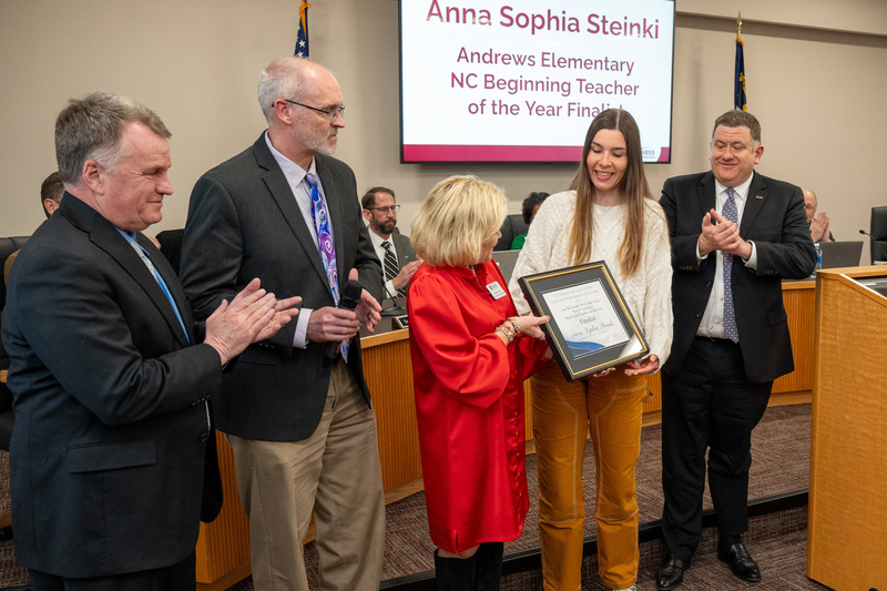 Photo of Anna Sophia accepting recognition plaque from NCCAT
