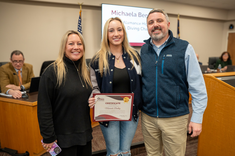 Photo of Michaela Bentley with coach and principal