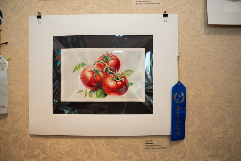 A watercolor painting of three tomatoes by student Iris Lin