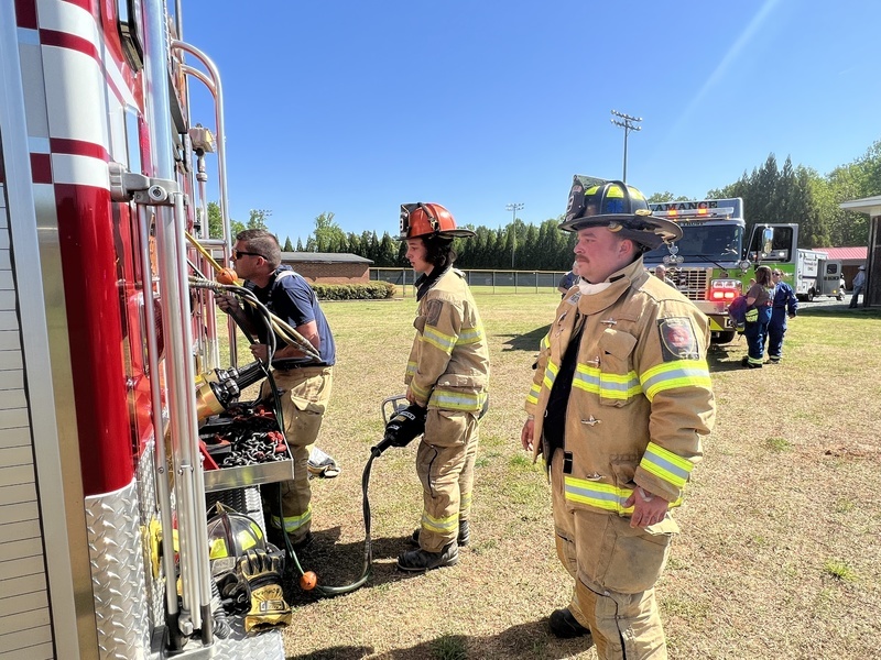 Firefighters working on back of firetruck