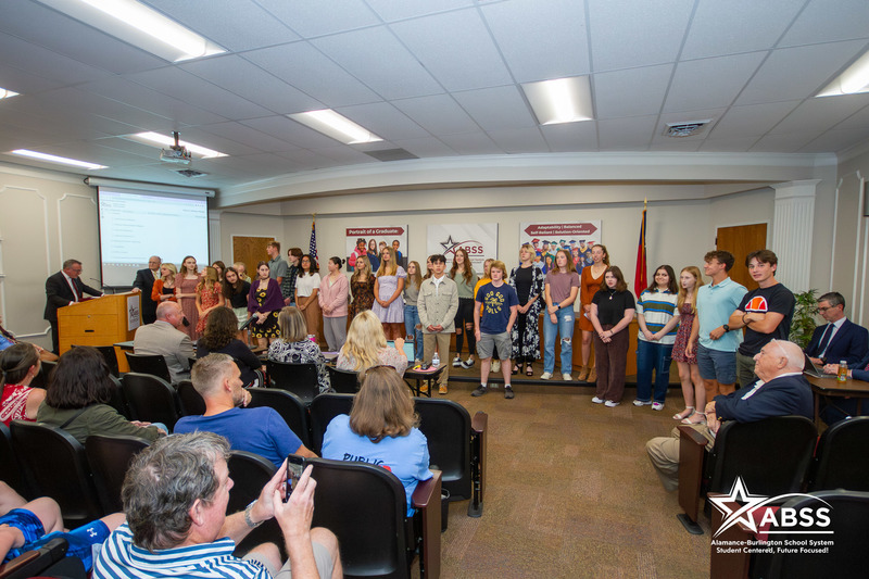 AP Scholars being recognized by Board of Education.  Posing in front of Board room