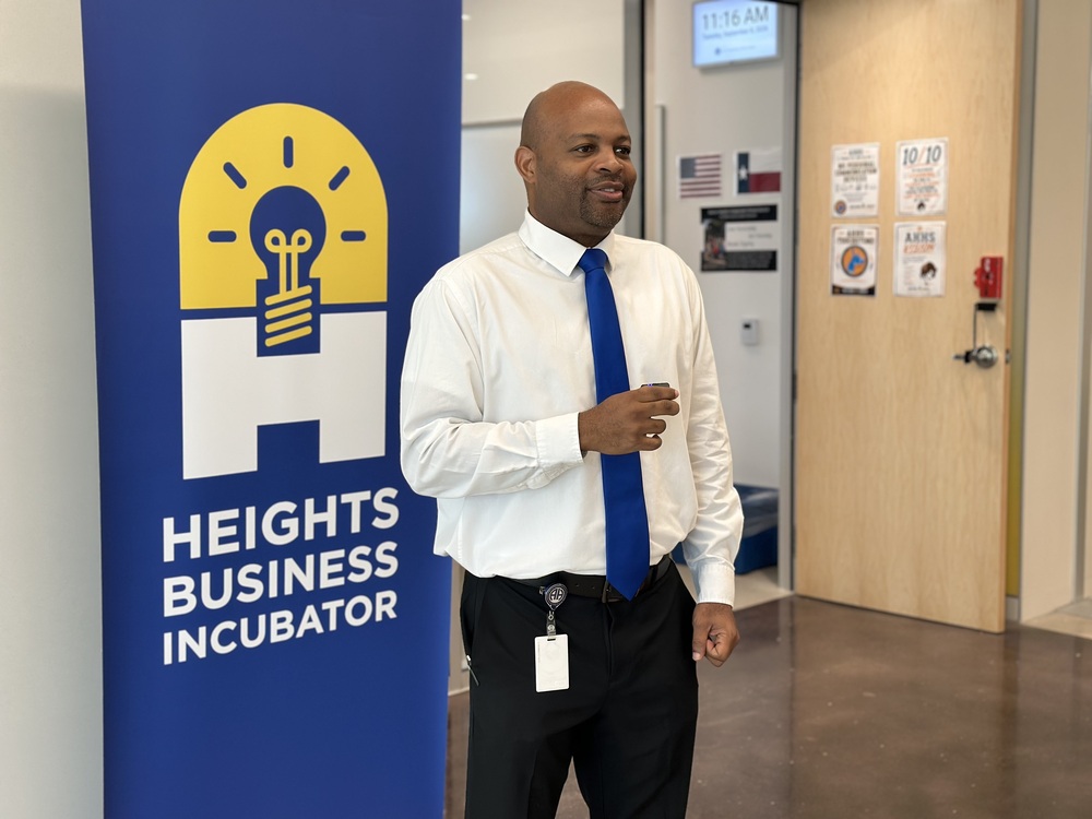 Mr. Fields speaking in front of Incubator program banner