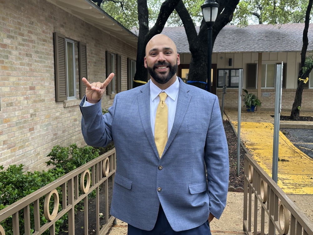 New Football Coach Rudy Nerio poses outside