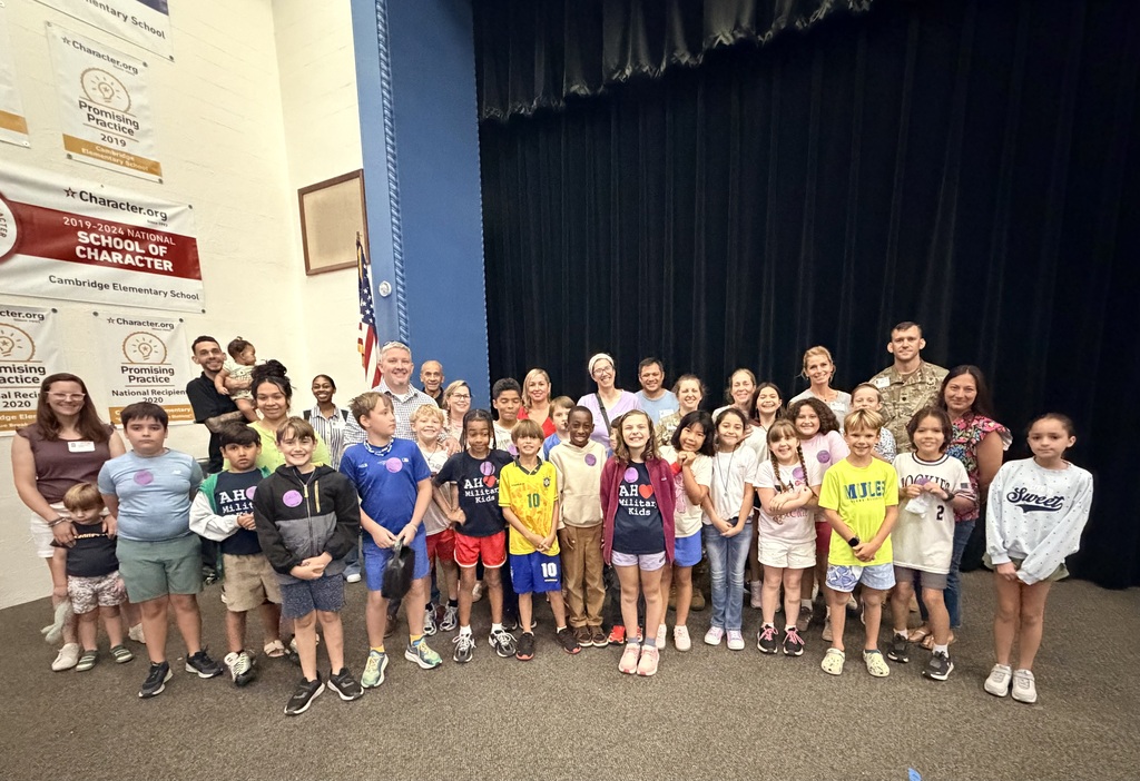 Military connected kids and parents pose in auditorium