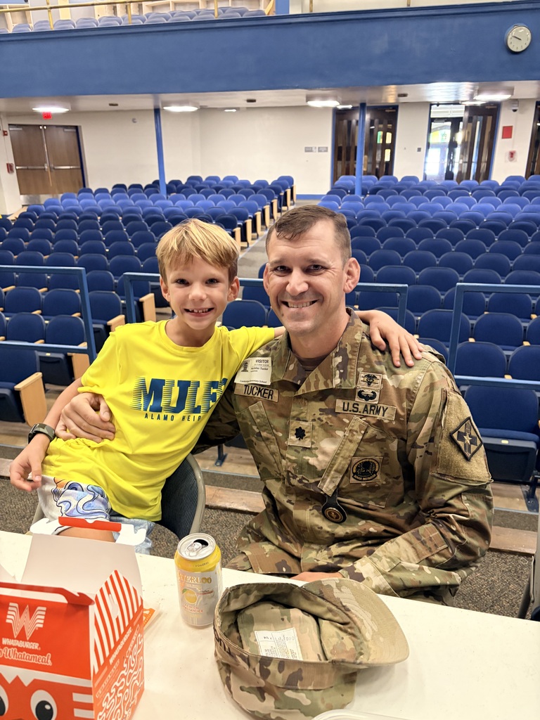 Father in fatigues eating lunch with son