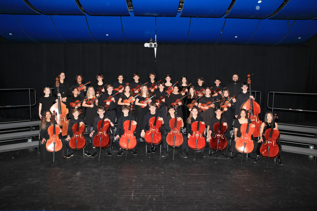 Junior School Chamber Orchestra poses with instruments and directors