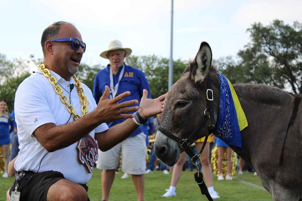 Assistant principals reacts after kissing mule at pep rally