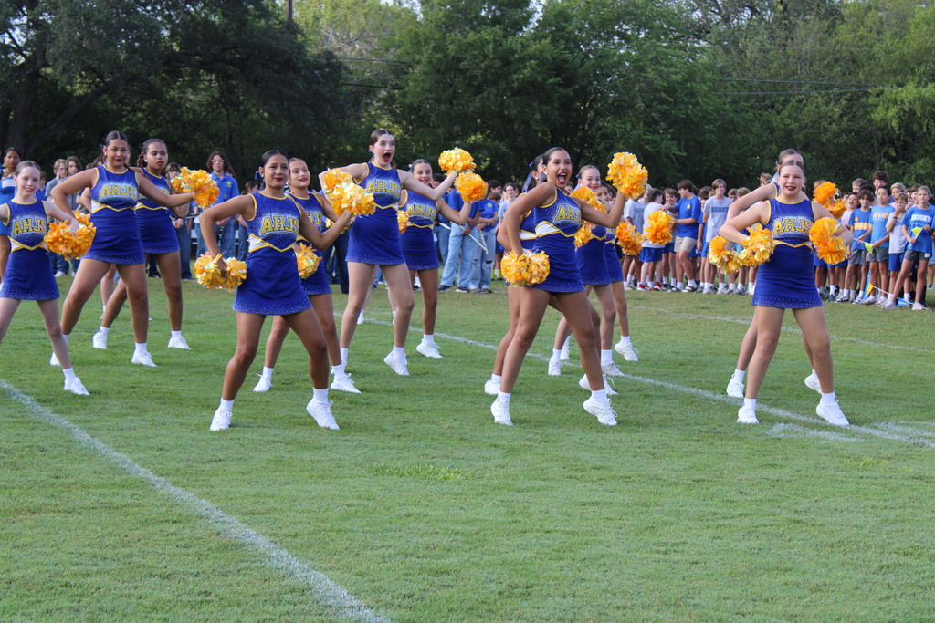 Dance team performs on football field during pep rally
