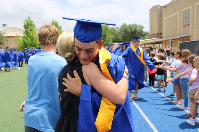 Graduate hugs Mom during senior walk