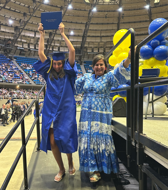 Mom and daughter celebrate as they walk off stage