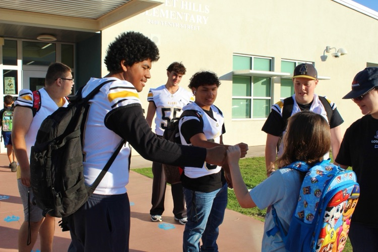 SHE Students with AHS Football team
