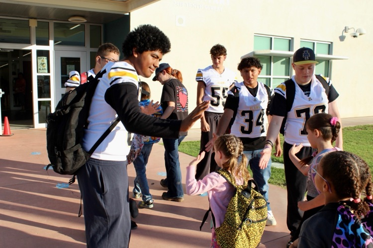 SHE Students with AHS Football team