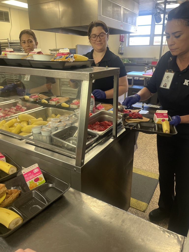 3 kitchen workers serving breakfast