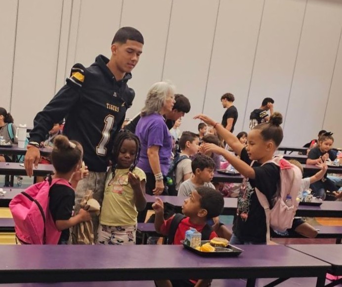 AHS Tigers Football team chatting with Desert Star Elementary Students