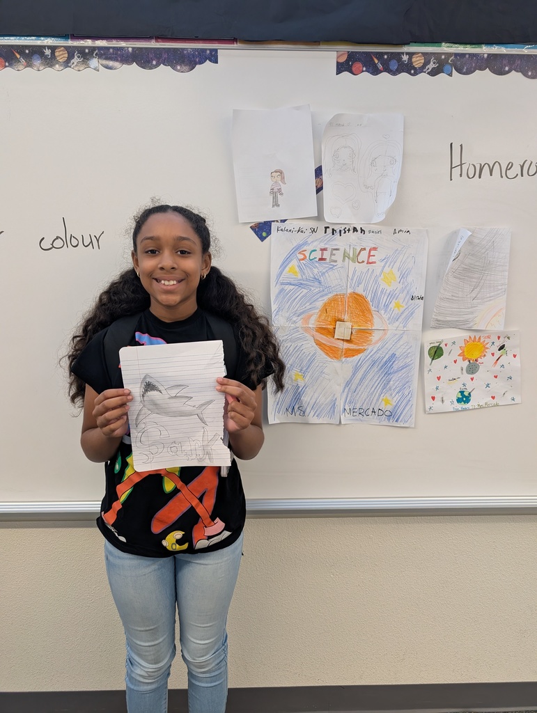student holding art work