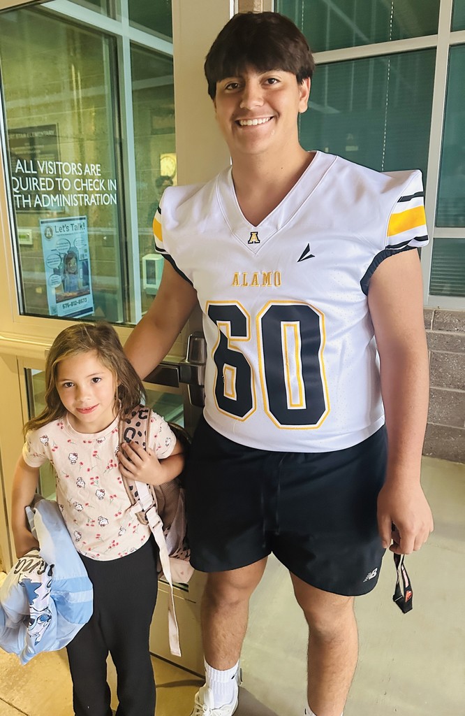 Alamogordo Tigers Football Team giving high fives to Desert Star kids.