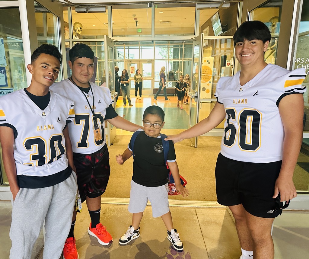 Alamogordo Tigers Football Team giving high fives to Desert Star kids.