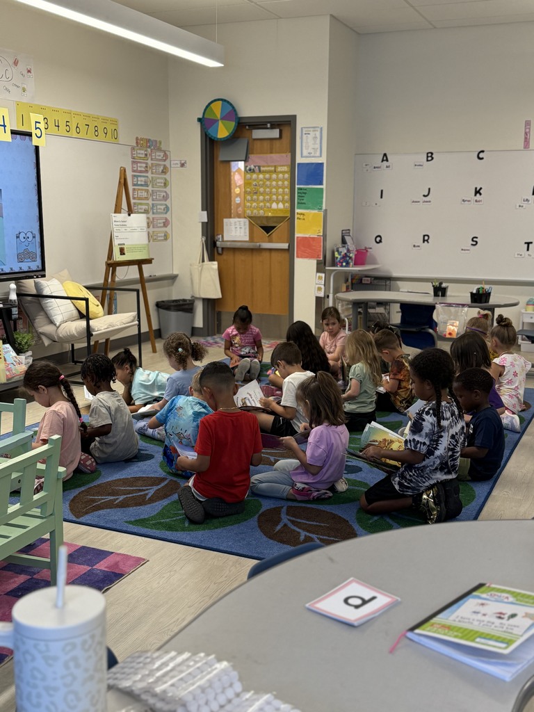 students paying attention to their book being read