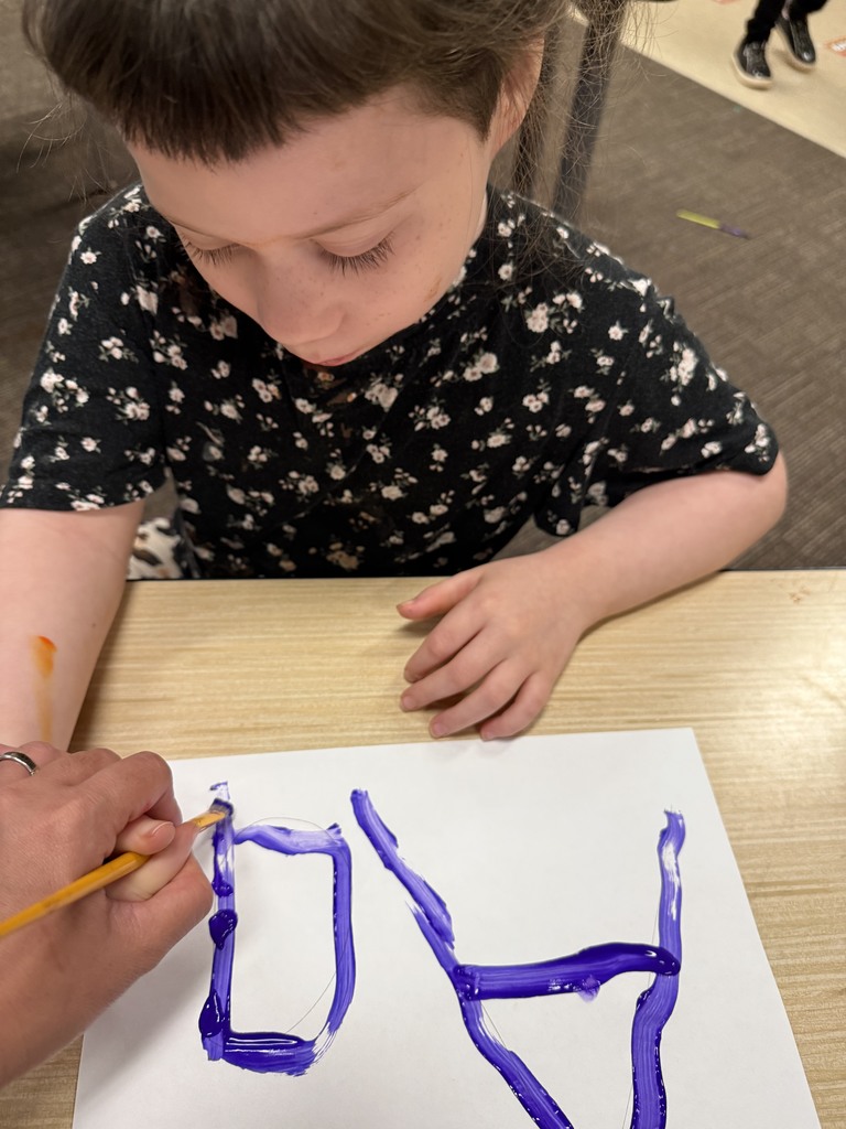 Student learning uppercase and lowercase “A” through painting