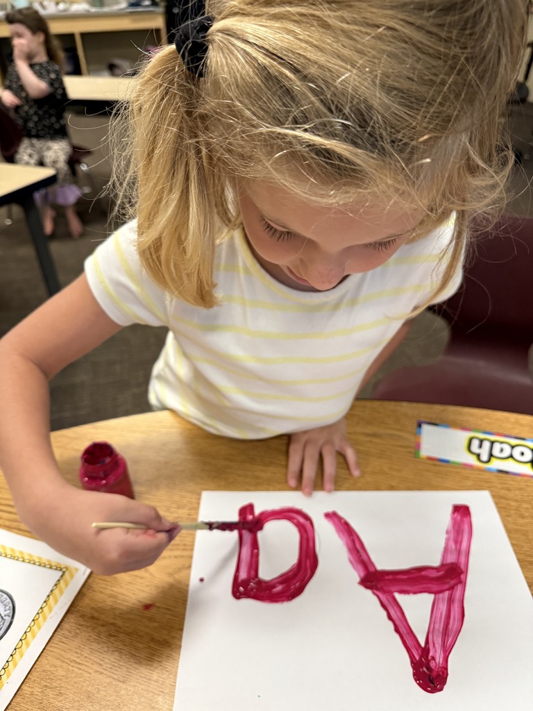 Student learning uppercase and lowercase “A” through painting