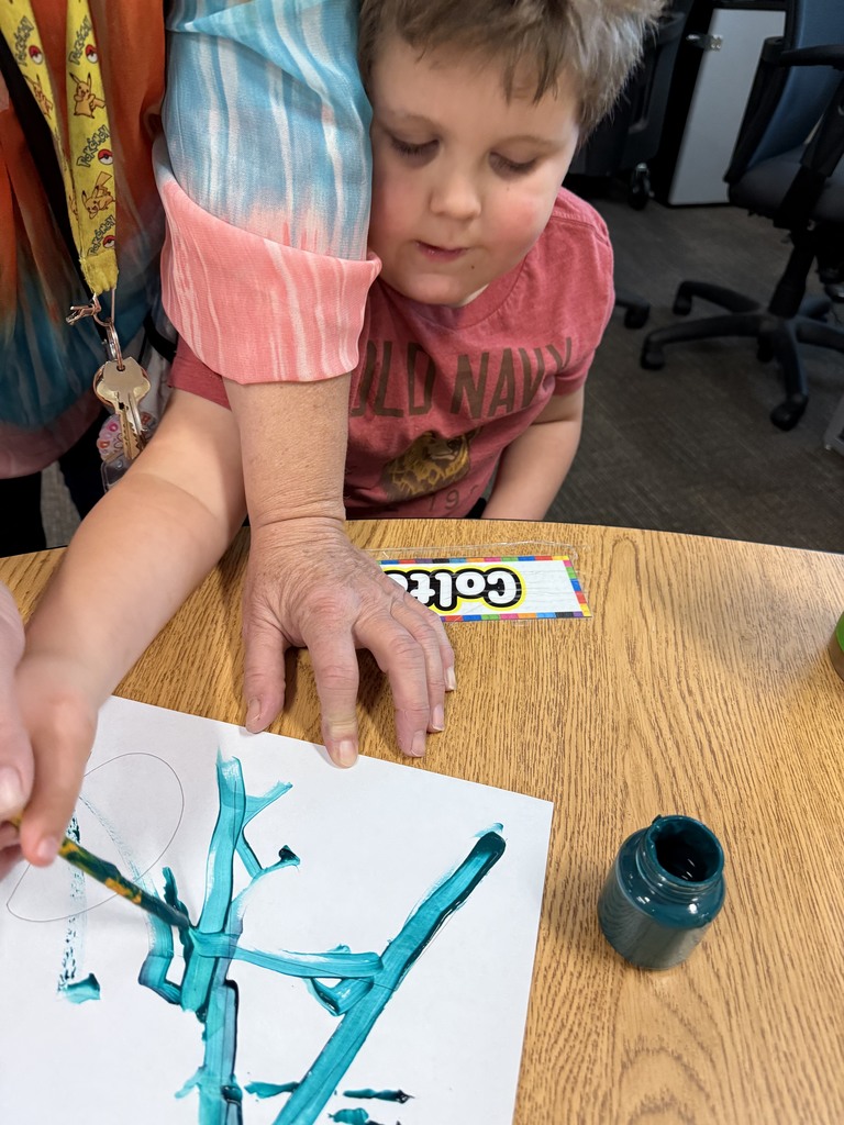 Student learning uppercase and lowercase “A” through painting