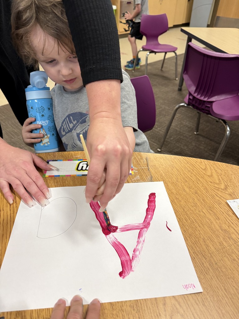 Student learning uppercase and lowercase “A” through painting