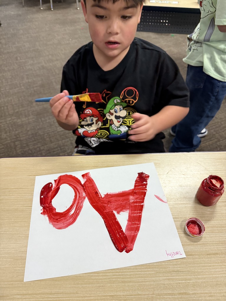 Student learning uppercase and lowercase “A” through painting