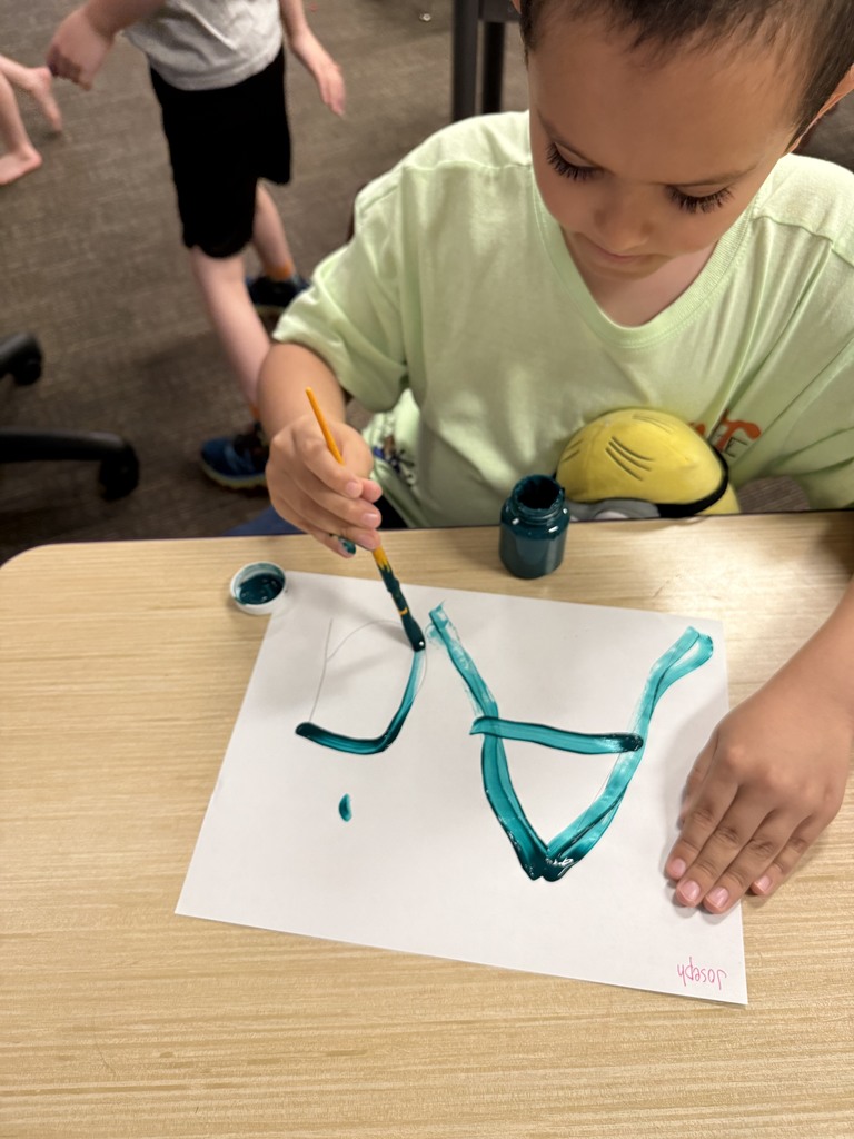 Student learning uppercase and lowercase “A” through painting
