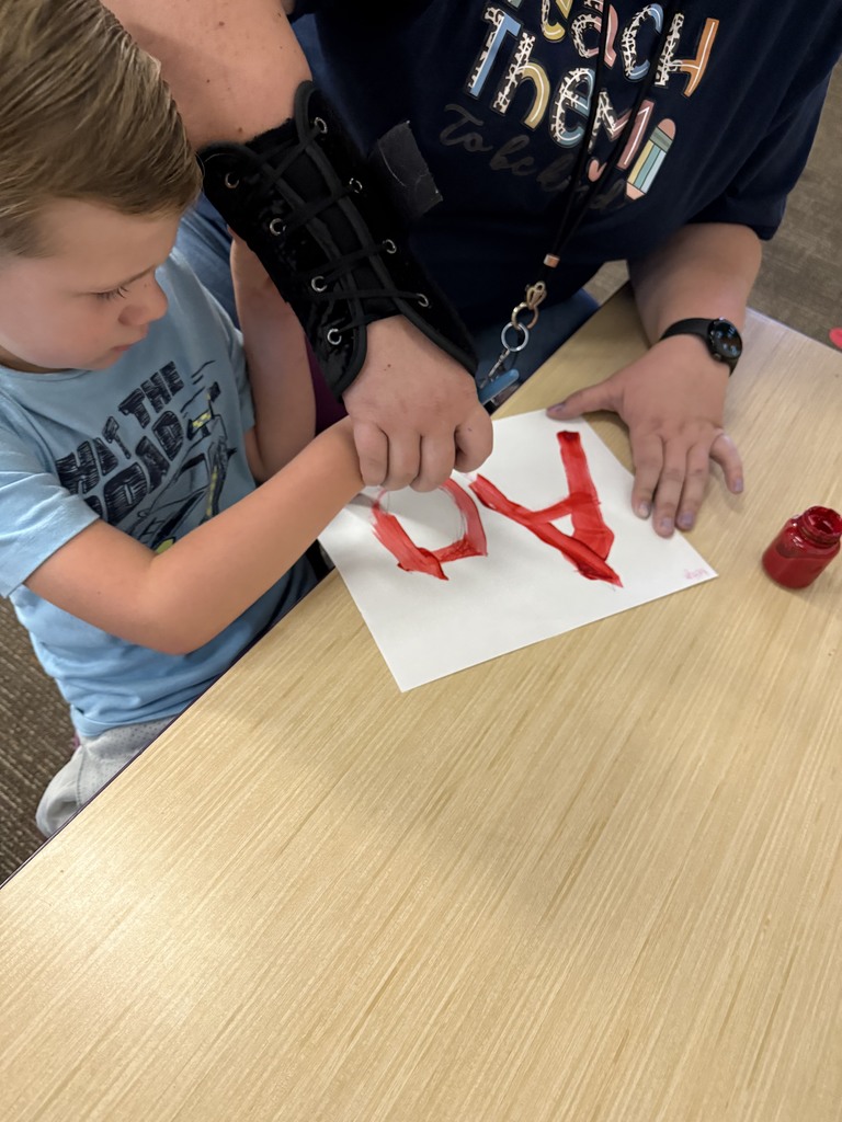Student learning uppercase and lowercase “A” through painting